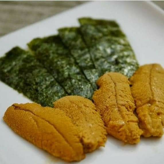 Sea urchin served with nori on a plate
